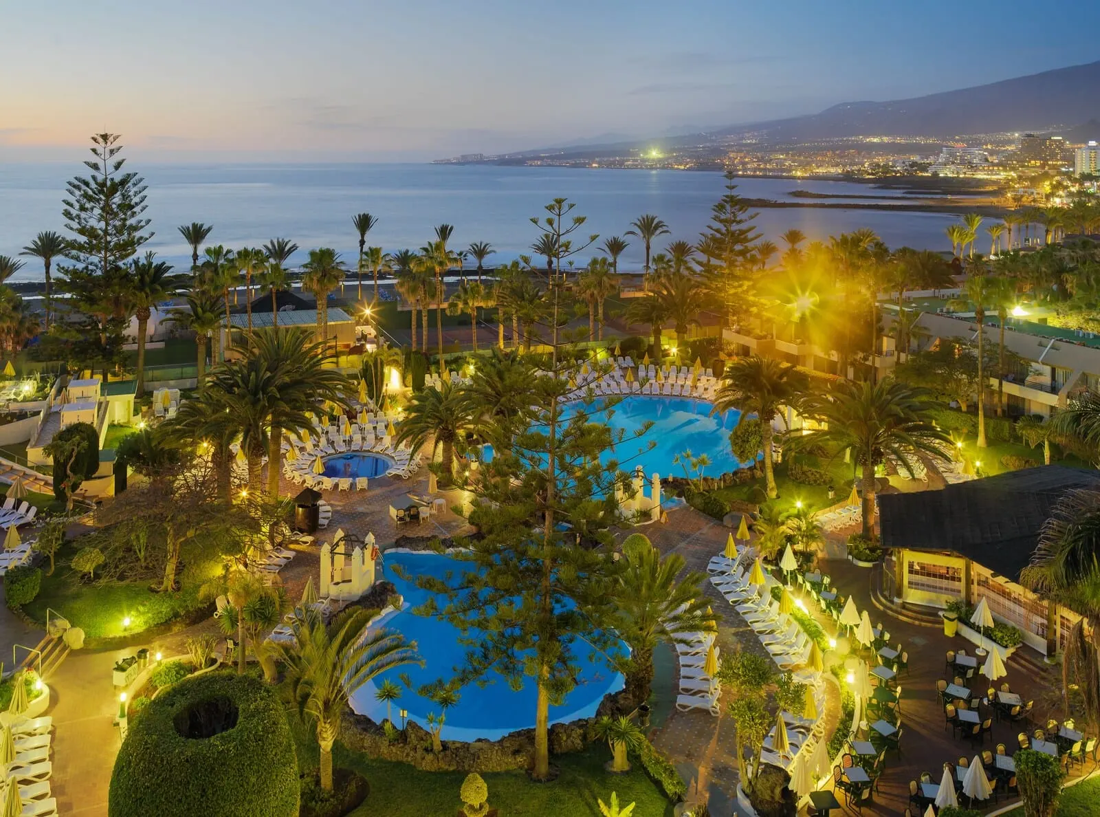 H10 Las Palmeras: A resort with multiple swimming pools, palm trees, and a view of the sea