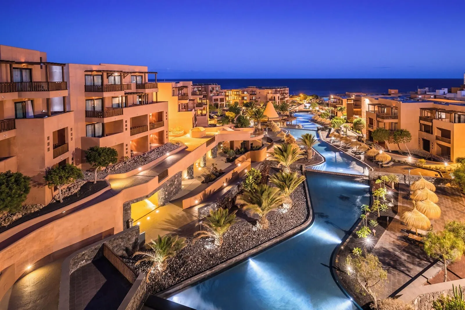 Barceló Tenerife: A resort with multiple buildings, a central swimming pool, and a view of the ocean