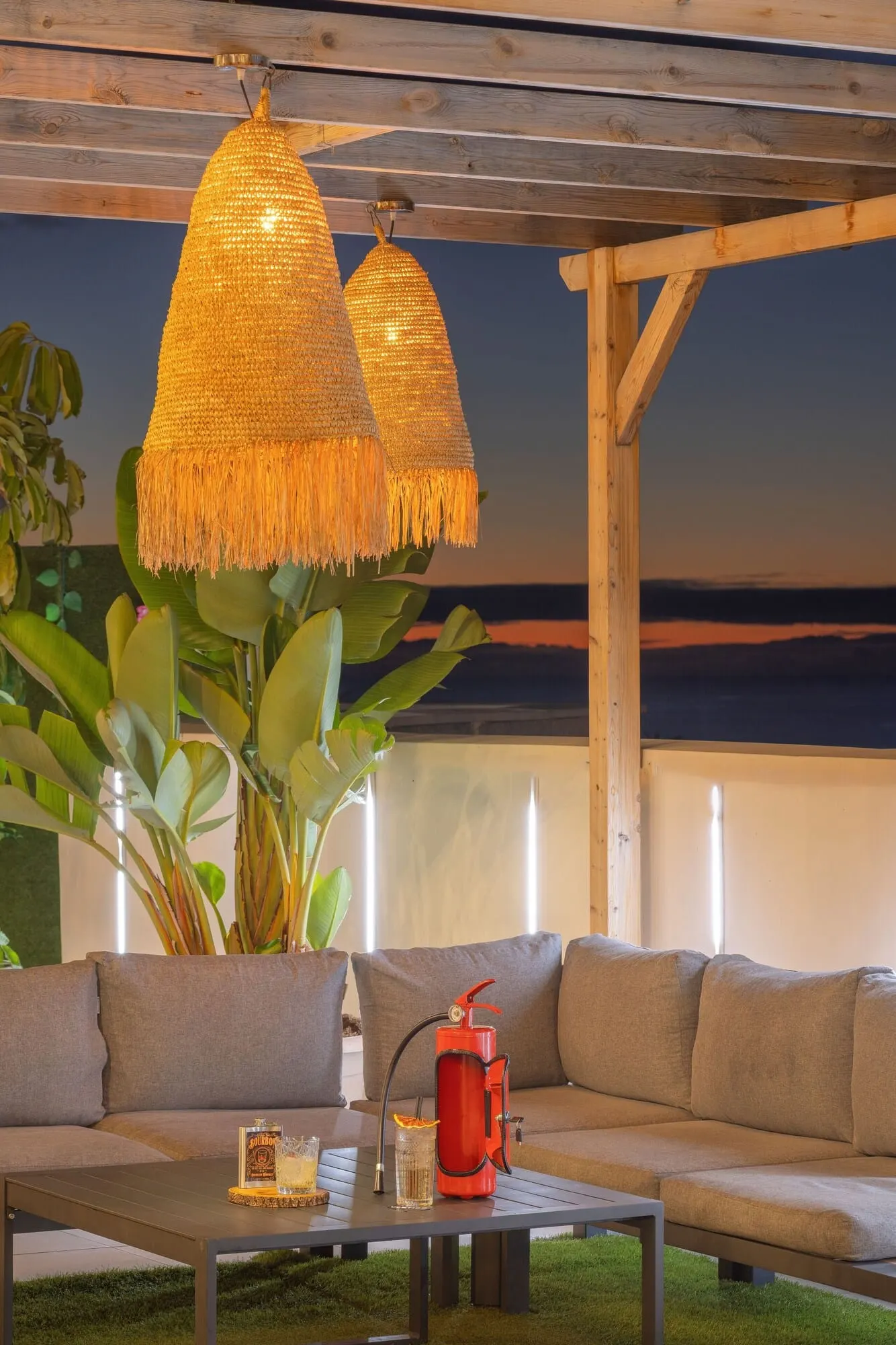 Alua Tenerife: A cozy outdoor seating area with a wooden pergola, a sofa