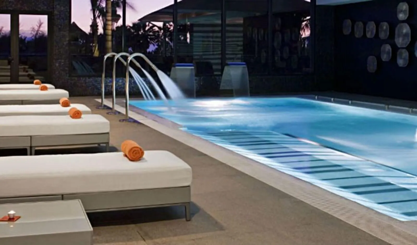 Rok Plaza: A pool area with lounge chairs and a water feature