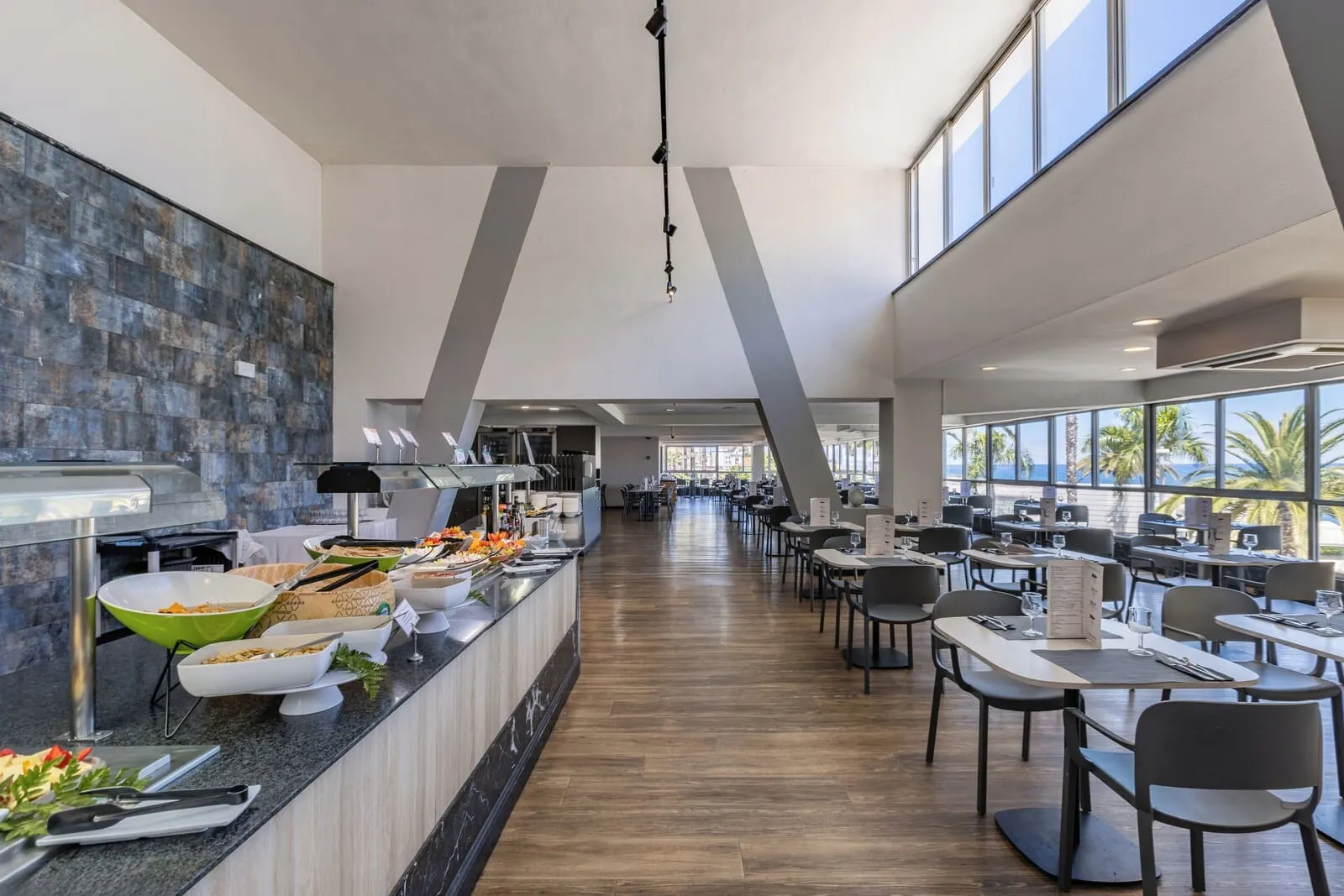 Catalonia Las Vegas: A modern dining area with a long counter, multiple tables