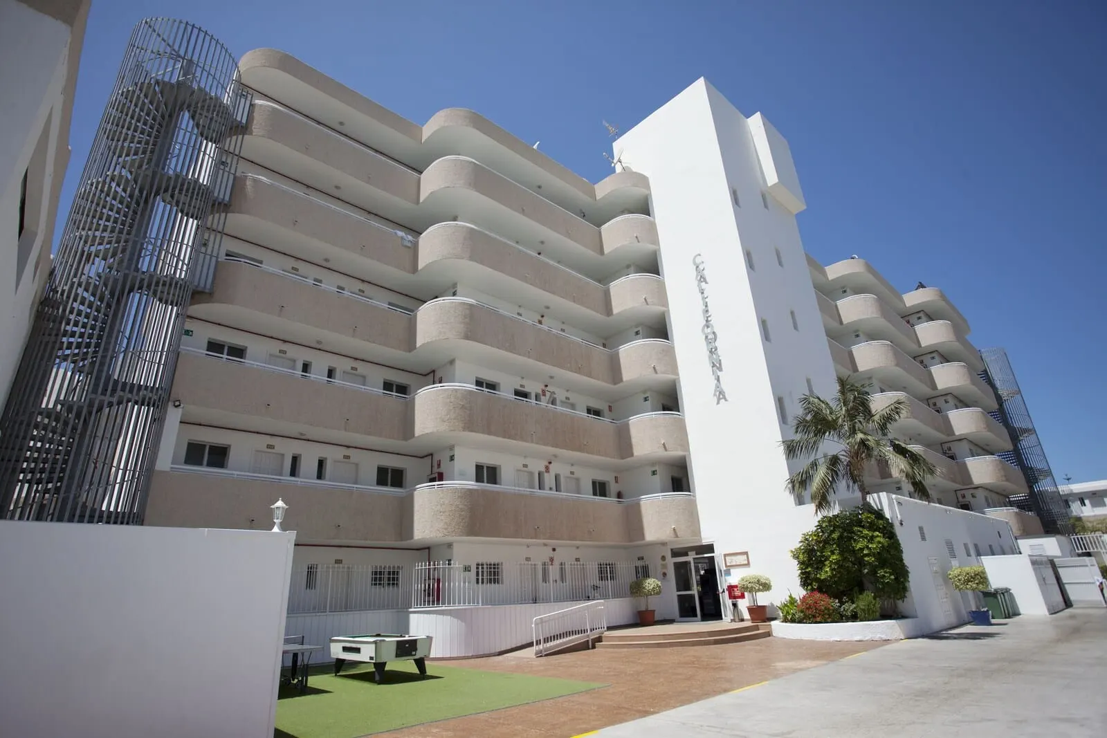 Coral California: A multi-story hotel with a central entrance, balconies on each floor