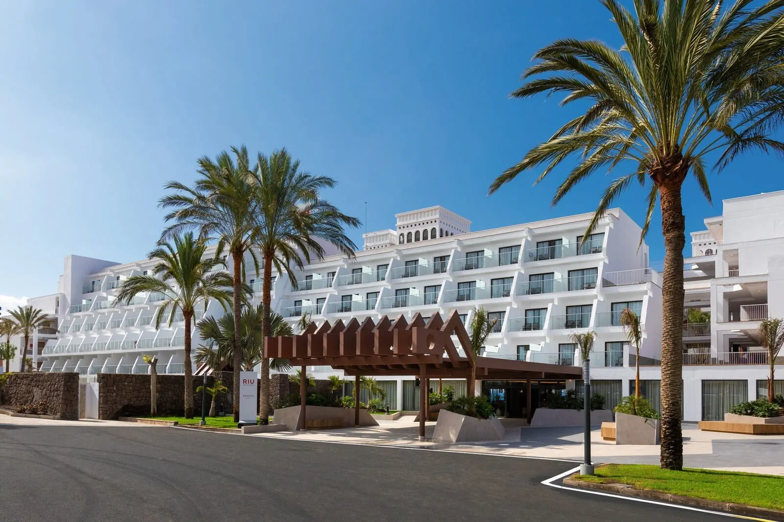 Hotel Riu Buenavista: A modern hotel with a white facade, multiple balconies, and palm trees
