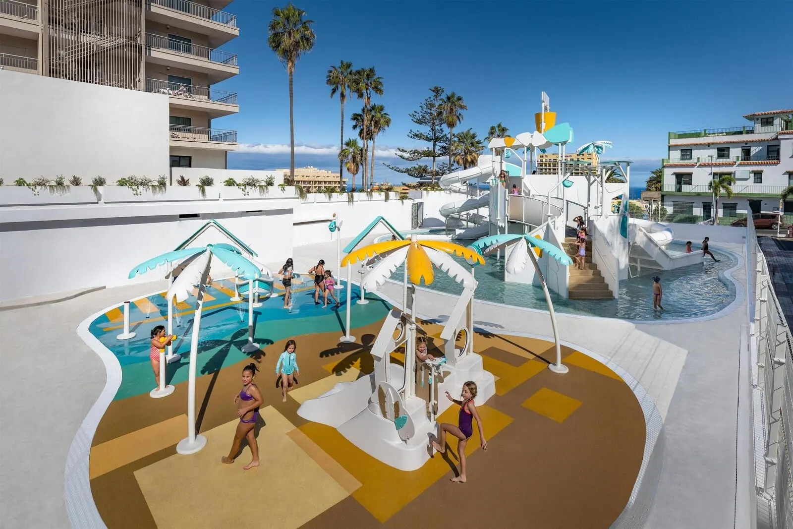 Hotel Atlantic El Tope: A water park area with slides and pools, surrounded by palm trees and buildings