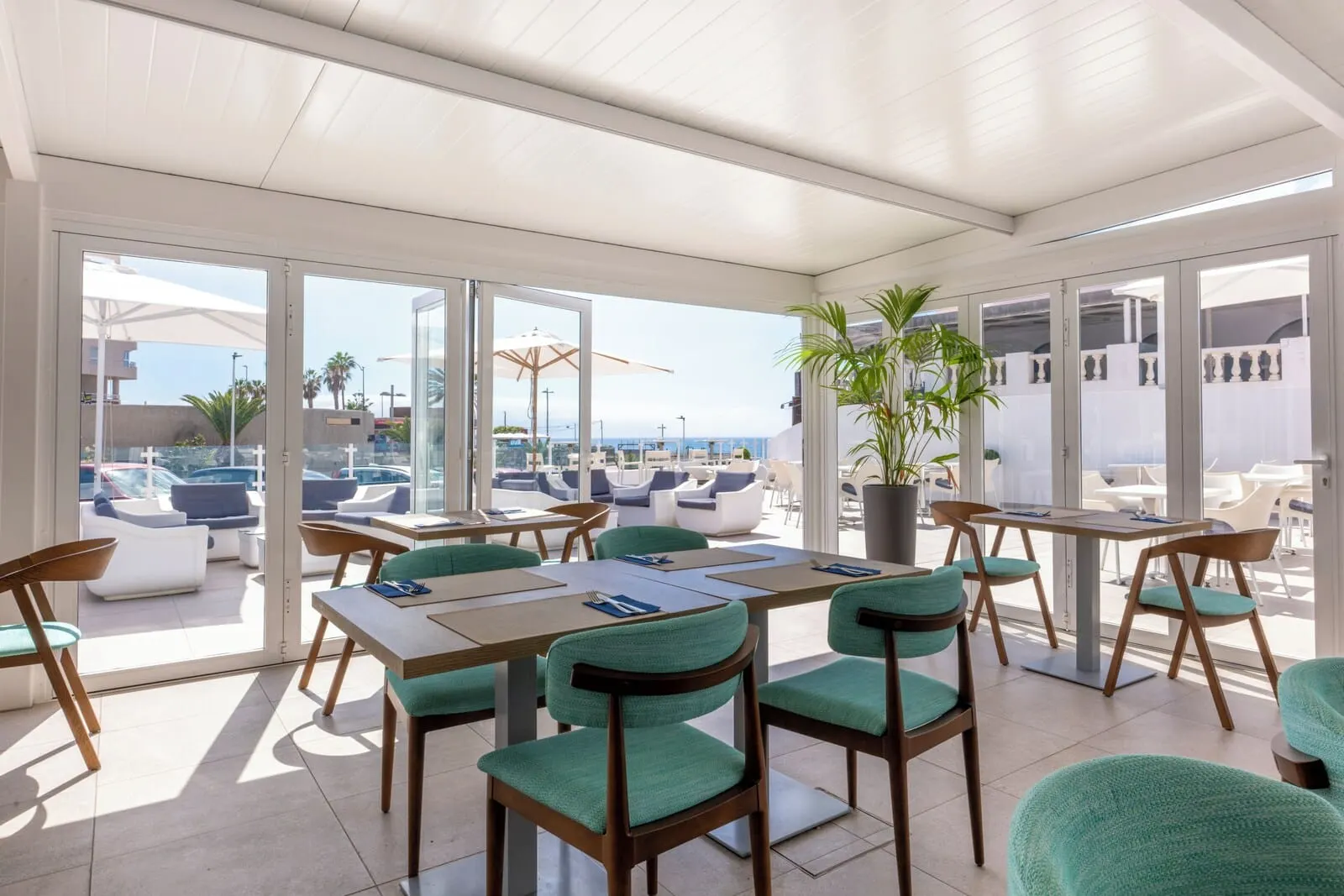 Ona El Marqués: A sunlit indoor dining area with a view of the sea