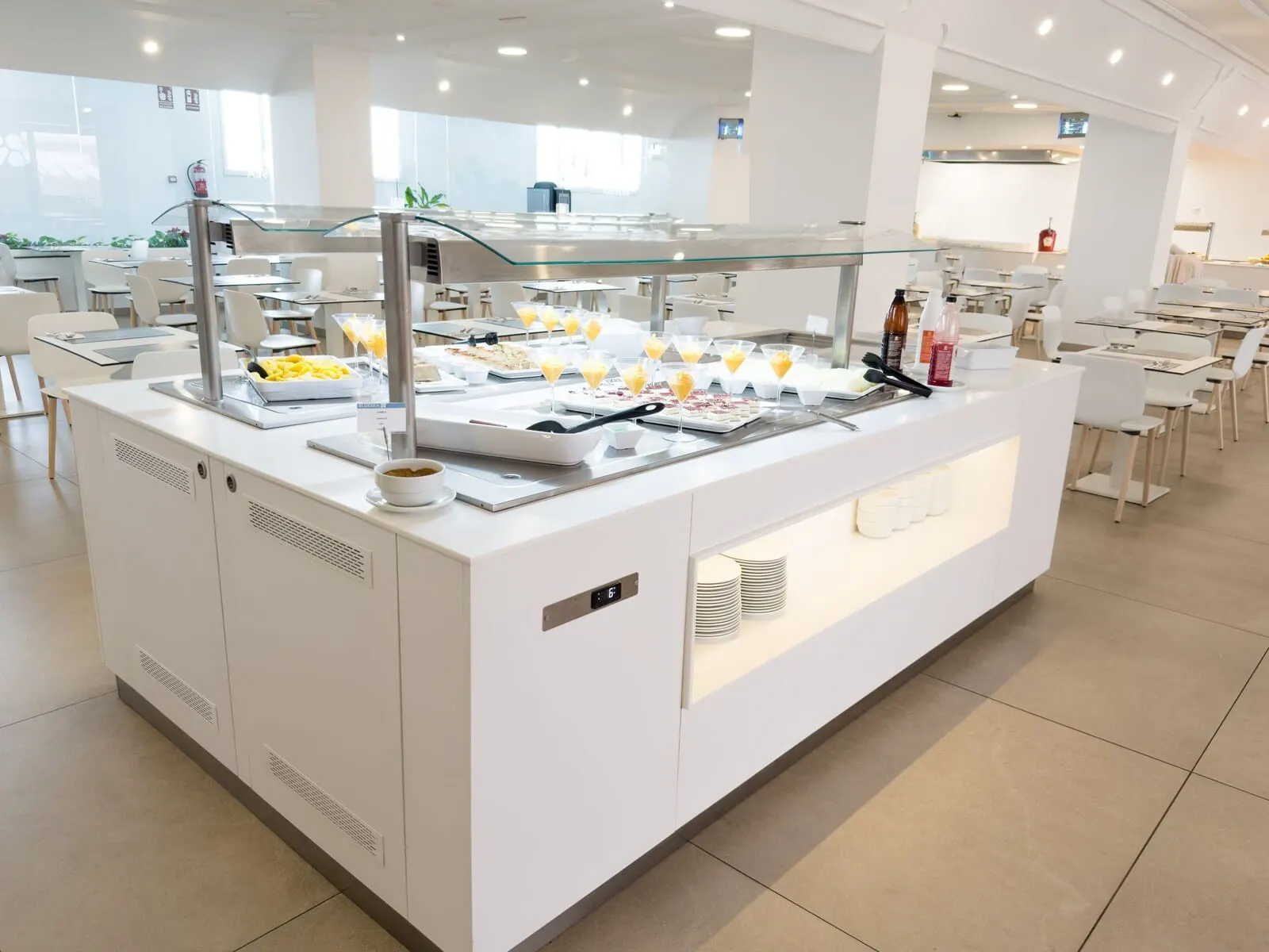 BlueSea Lagos de César: A buffet area with a glass display case, various food items, and a digital clock