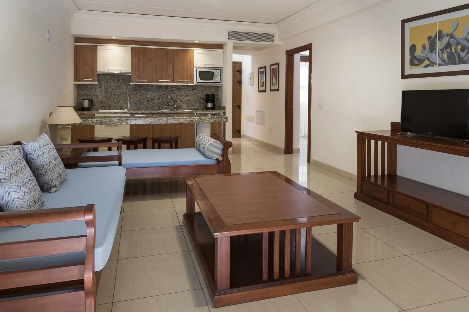 Marylanza Suites & Spa: A modern living room with a sofa, a coffee table
