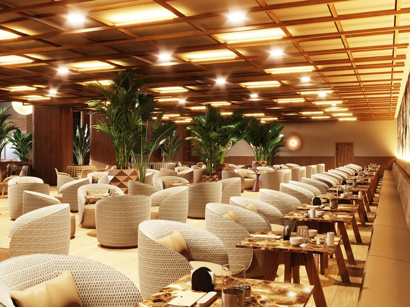 Bahia Principe Explore Costa Adeje: A modern restaurant with wicker furniture, wooden tables, and potted plants