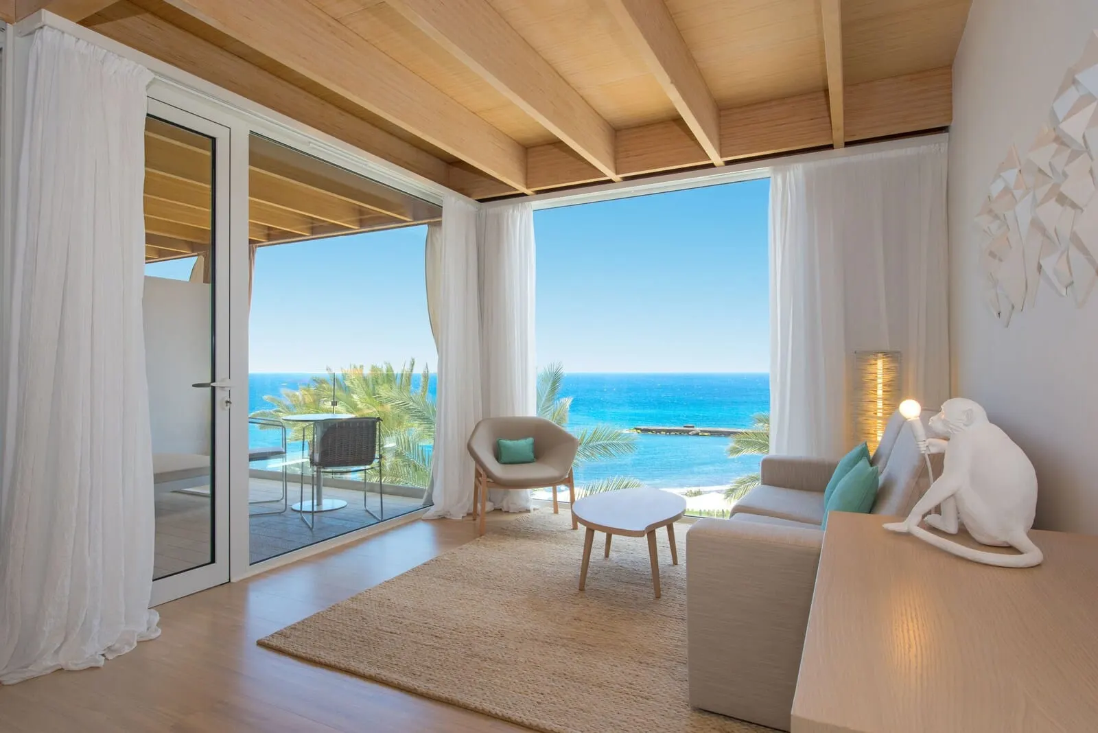 JOIA Salomé by Iberostar: A spacious living room with a large sliding glass door leading to a balcony overlooking