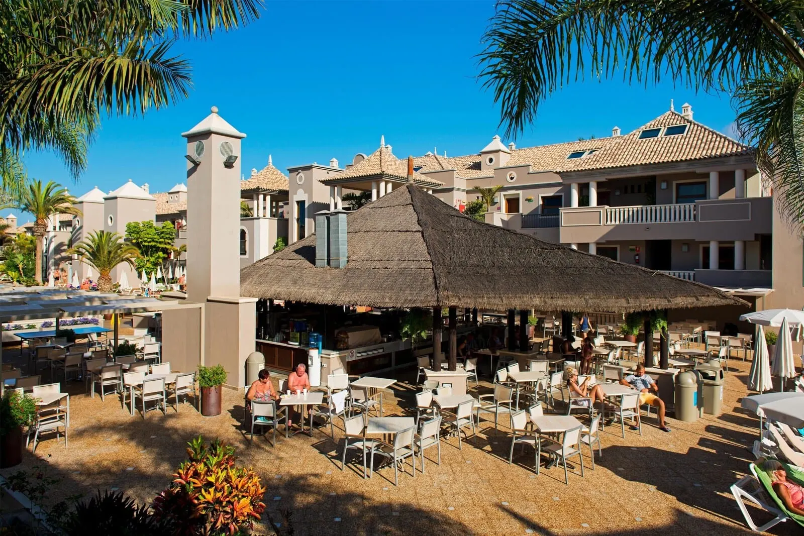 Marylanza Suites & Spa: A resort with outdoor seating, a central thatched structure