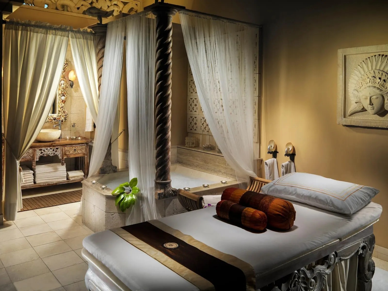 Royal Garden Villas & Spa: A four-poster canopy bed with a white canopy, a wooden headboard