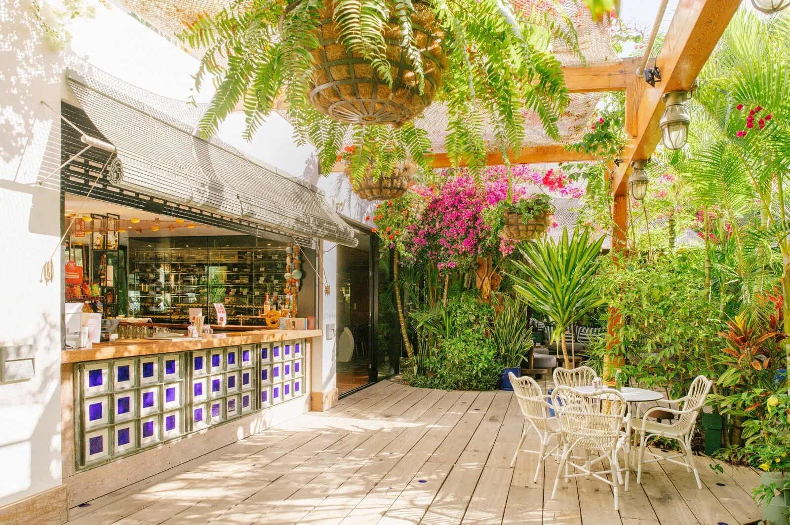 Parque Santiago III: An outdoor patio with wooden flooring, white wicker chairs