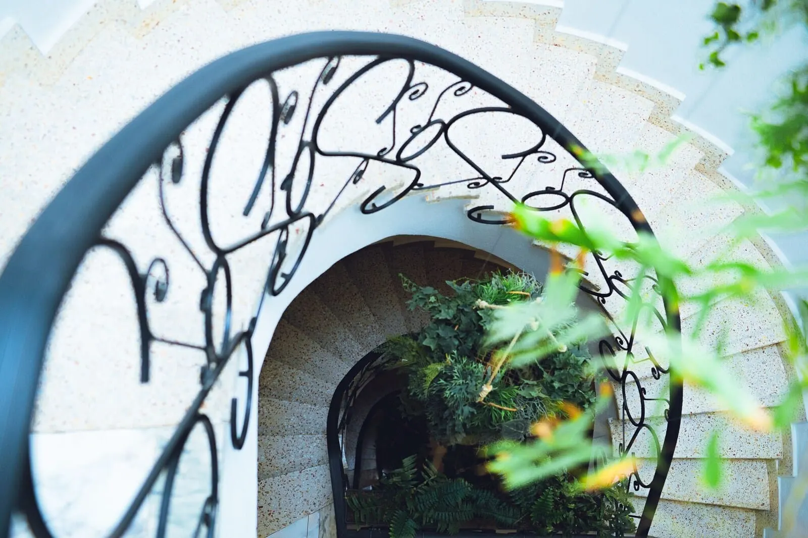 Hotel Ventus: A stone archway with a metal railing and greenery inside