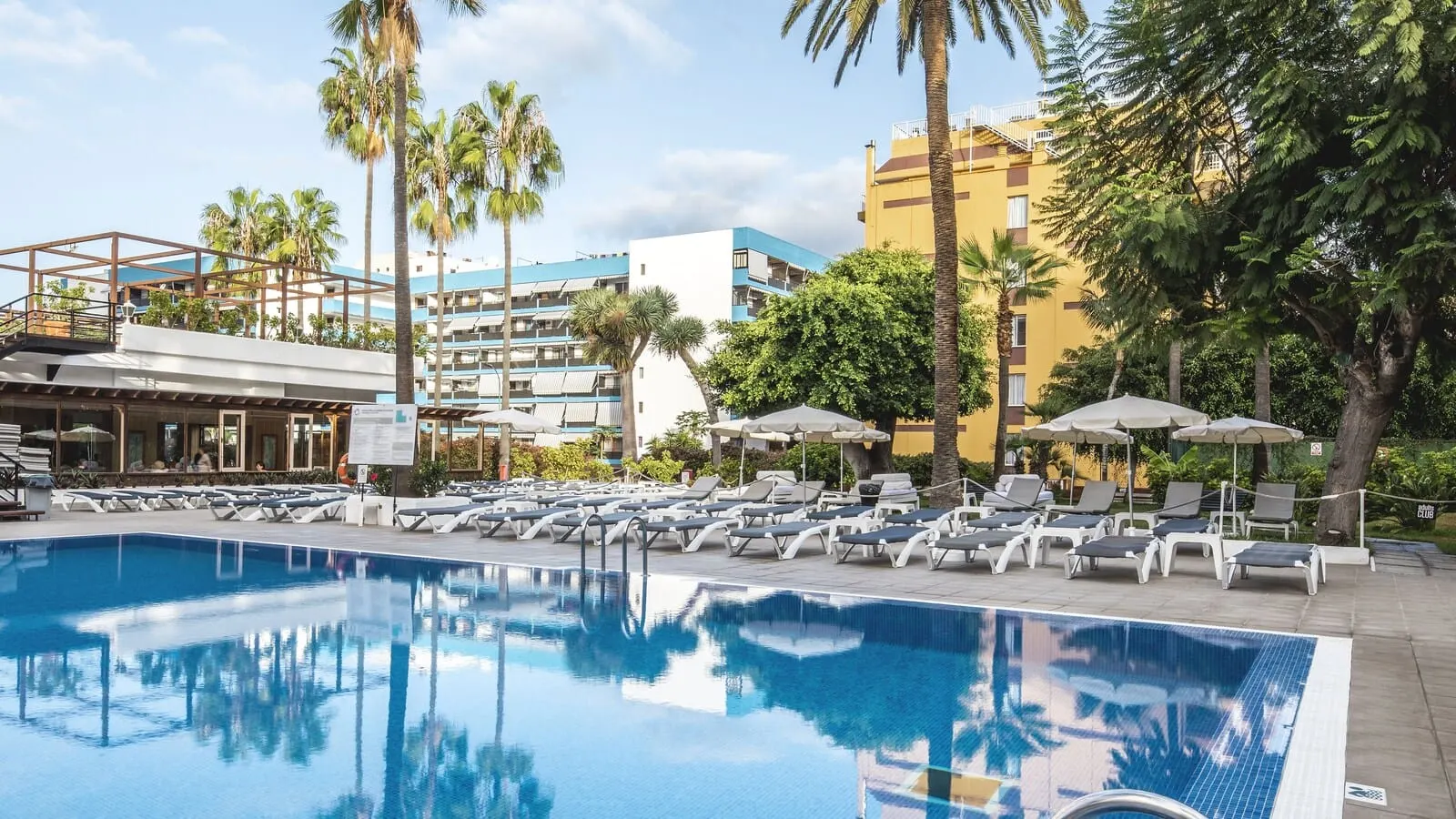Be Live Adults Only Tenerife: A swimming pool with lounge chairs and umbrellas