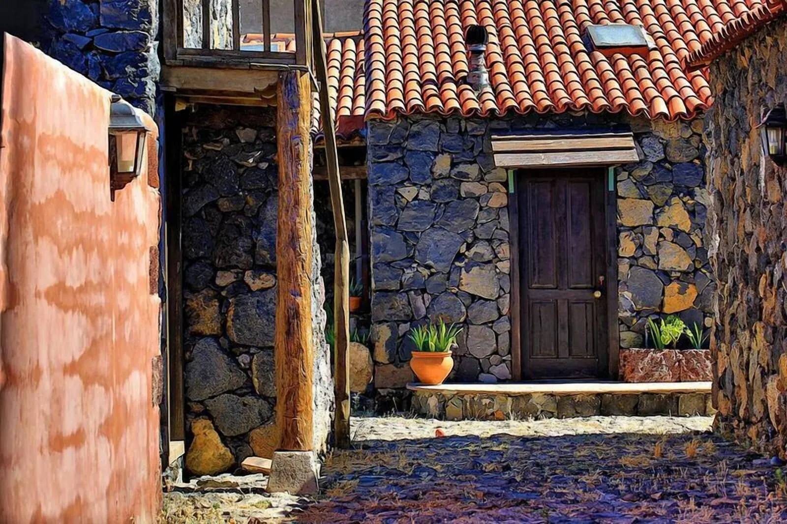 Hotel Rural Caserío Los Partidos: A stone building with a tiled roof, a wooden door, and potted plants on the steps