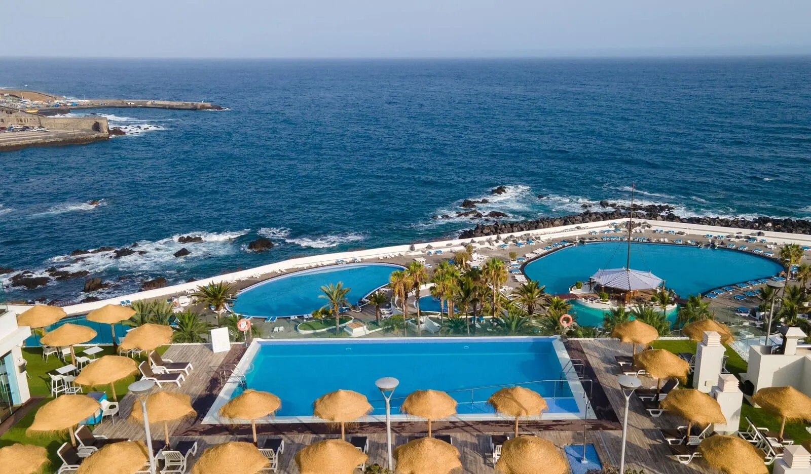 Hotel Vallemar: A resort with a large pool, a smaller pool, and a beach area with umbrellas