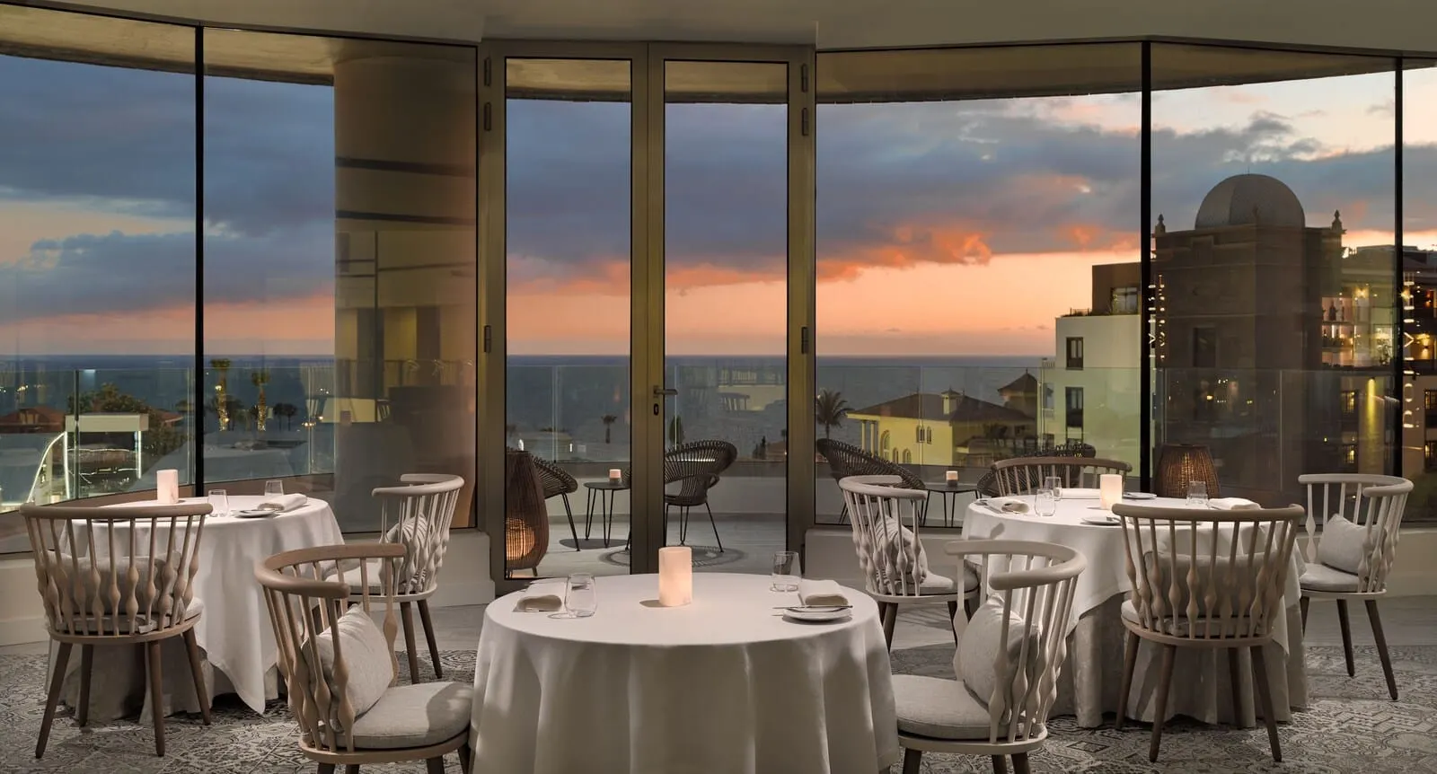 GF Victoria: A rooftop dining area with round tables and chairs