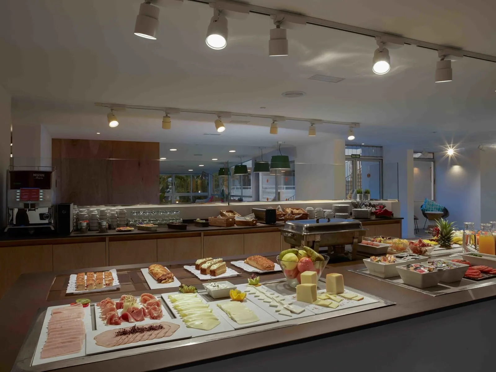 Route Active Hotel: A buffet setup with various food items and a coffee machine