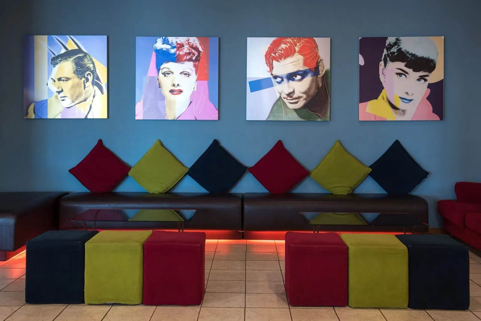 Hotel Las Águilas Tenerife, Affiliated by Meliá: A modern lounge area with a sofa and colorful cushions, a wall with vibrant artwork