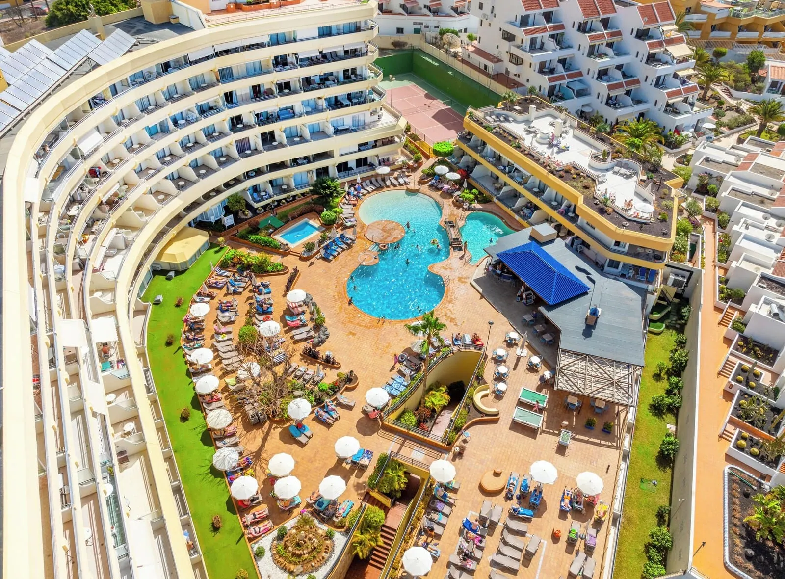HOVIMA Santa María: A multi-level hotel with a central pool area, outdoor lounge chairs, and a sun terrace