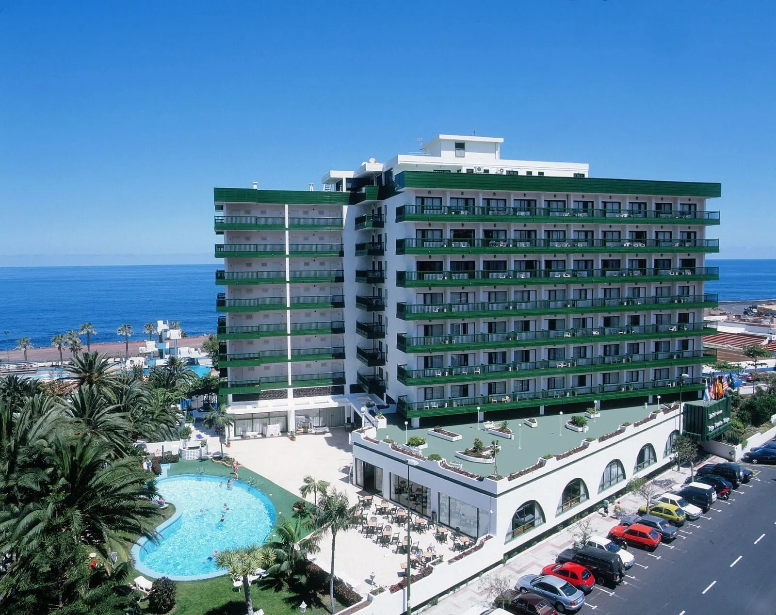 Sol Puerto de la Cruz Tenerife: A multi-story hotel with a rooftop pool and a view of the ocean