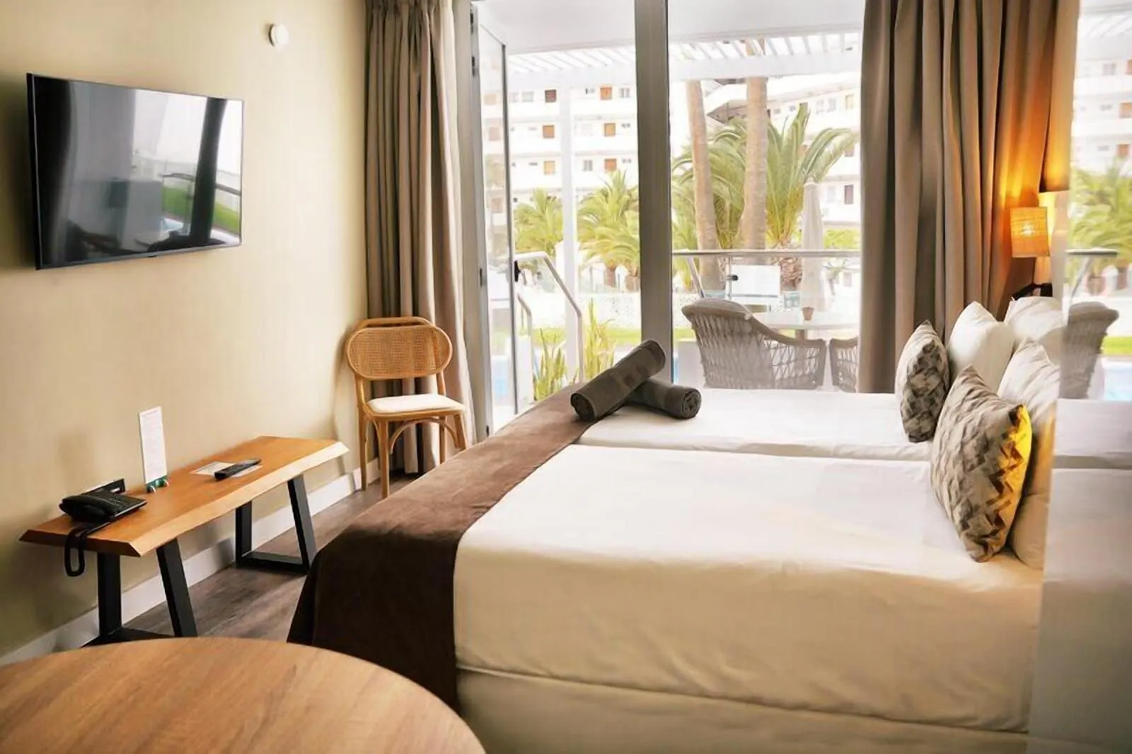 Coral Ocean View: A hotel room with two beds, a TV, a desk