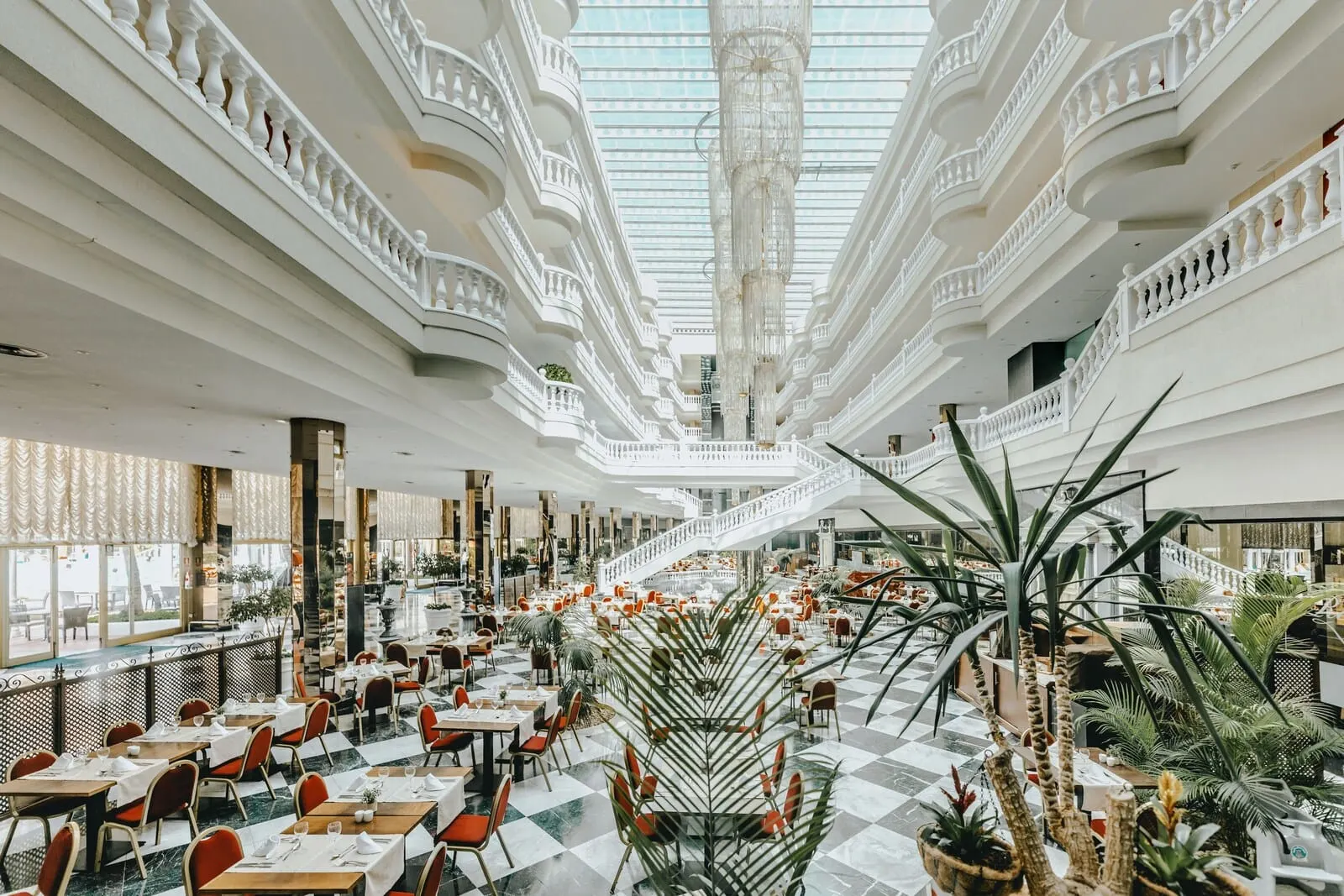 Cleopatra Palace: A spacious atrium with multiple dining areas, a central staircase