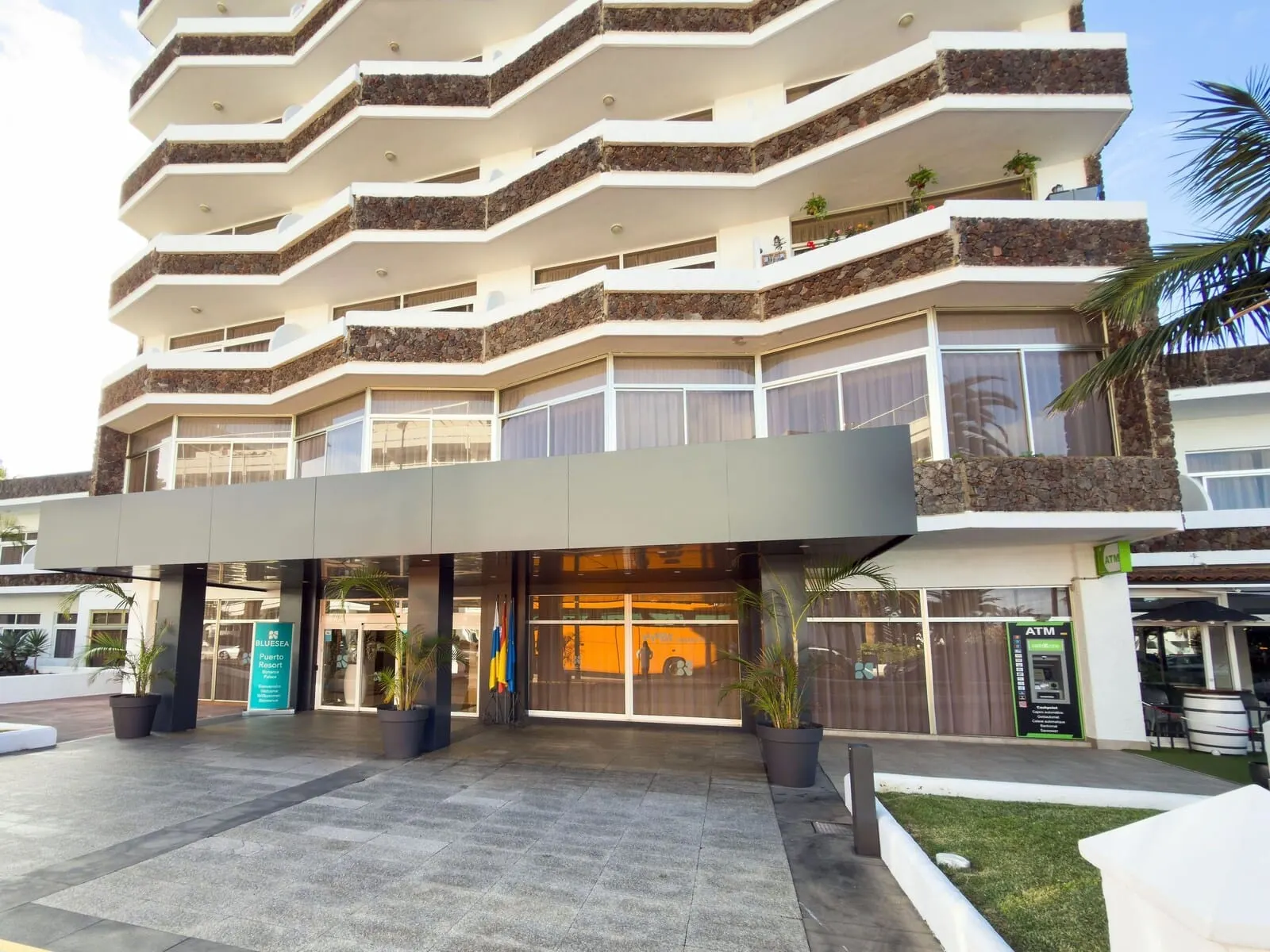 BLUESEA Puerto Resort: A multi-story hotel with a modern design, featuring balconies with stone accents