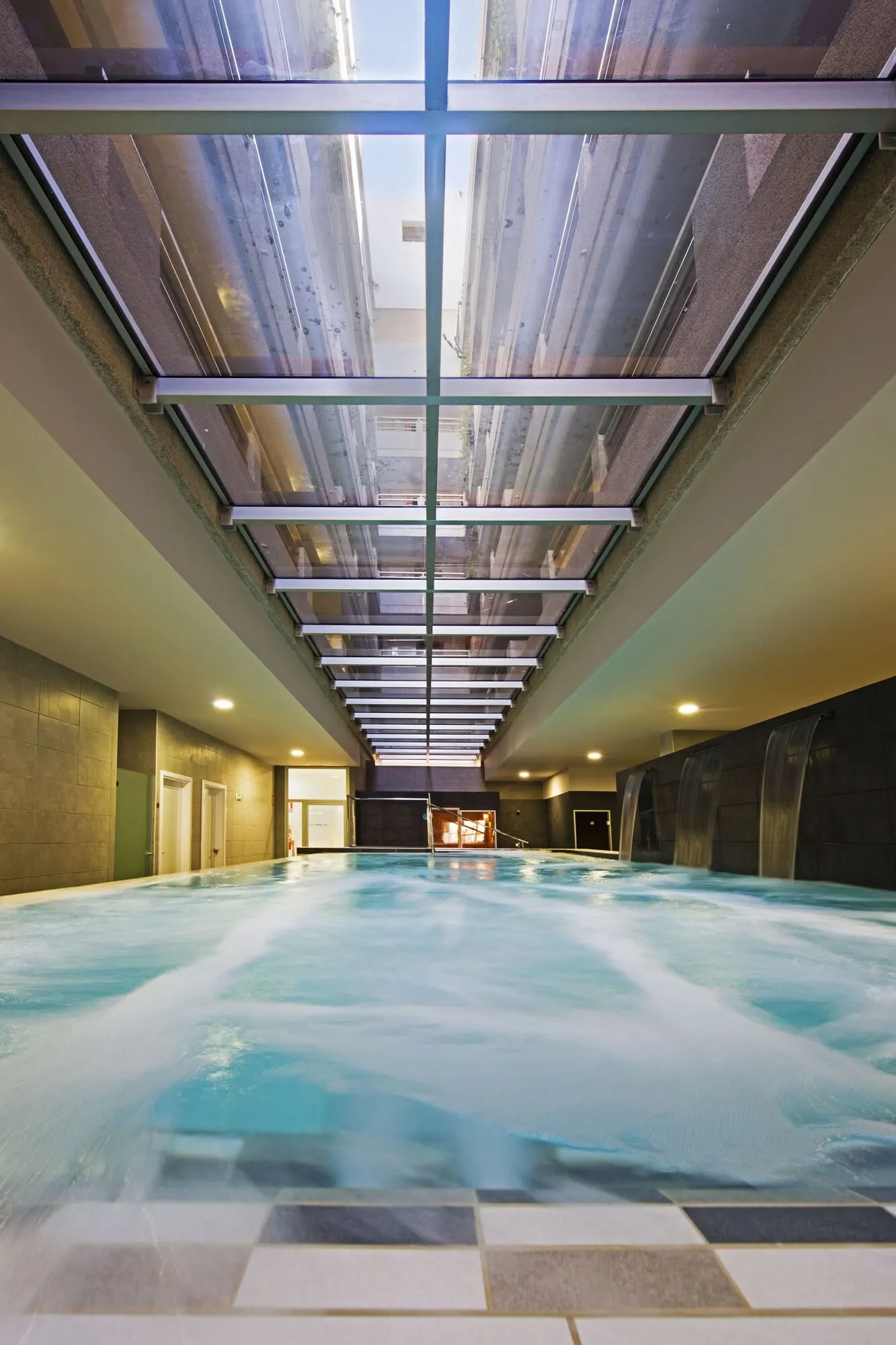 KN Aparthotel Columbus: An indoor swimming pool with a high ceiling and skylights