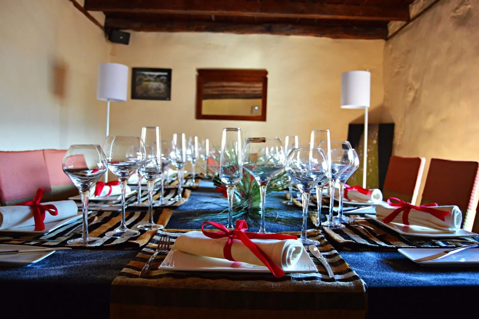 Hotel La Casona del Patio: A table set for a formal dinner with multiple wine glasses and folded napkins tied