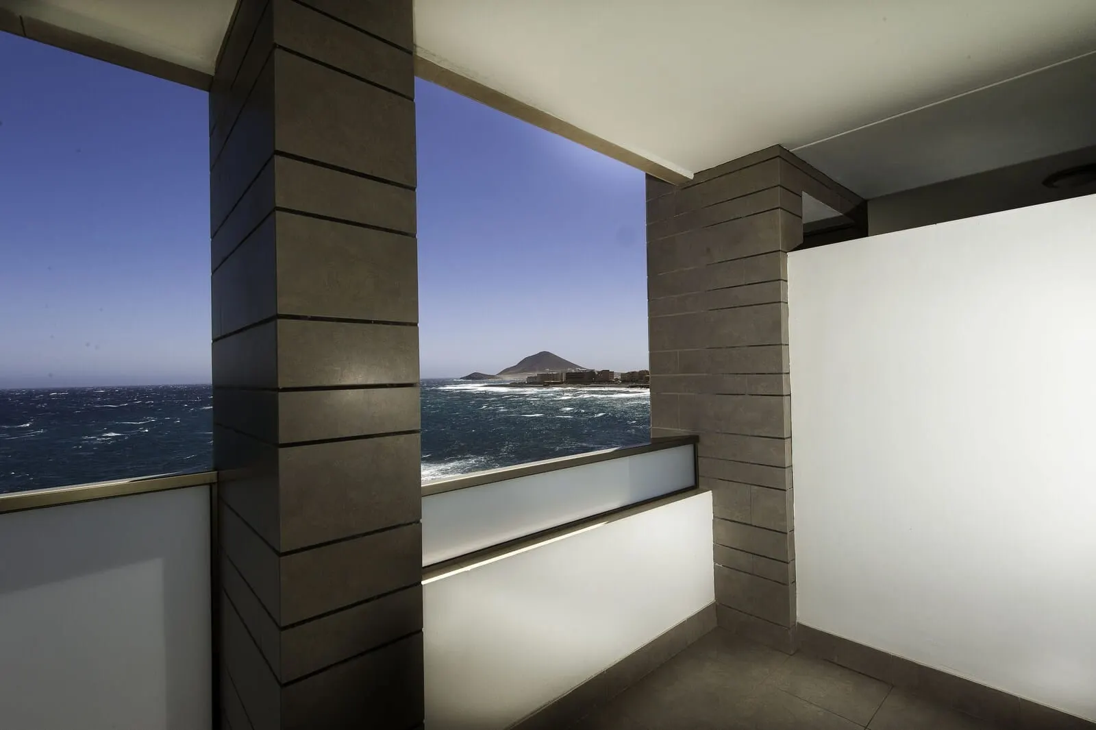 KN Hotel Arenas del Mar: A balcony with a view of the ocean and a distant mountain
