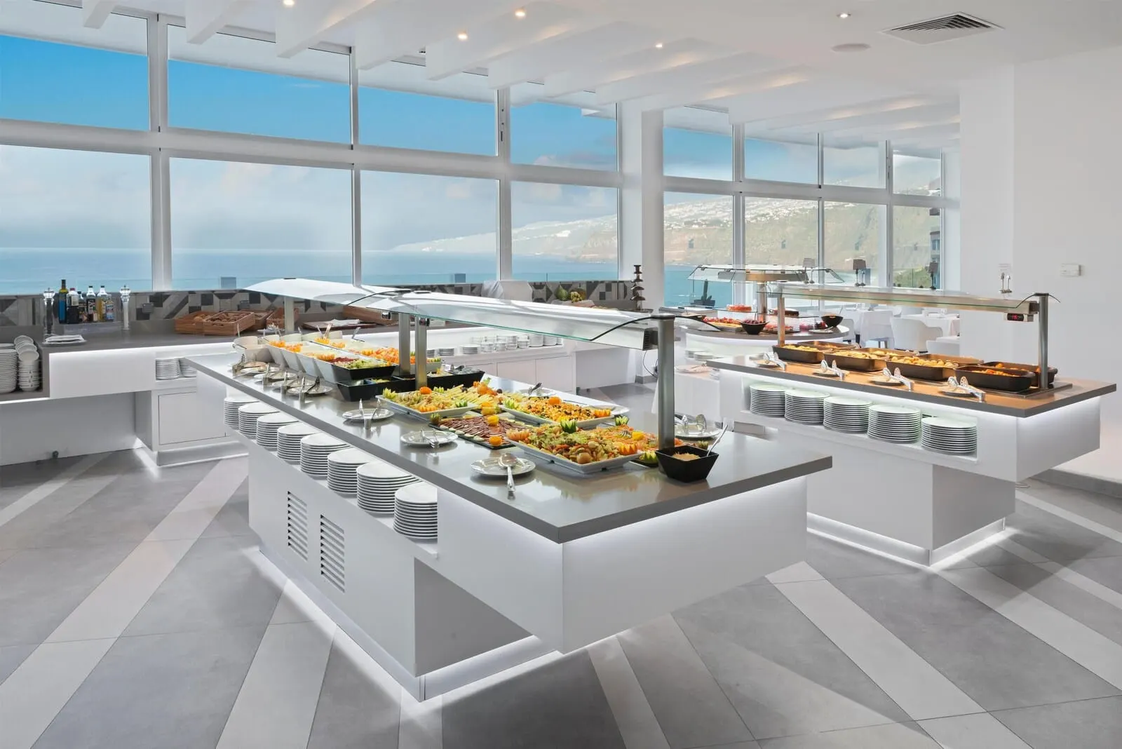 Atlantic Mirage Suites & Spa: A buffet setup with a variety of food items and a view of the sea through large windows