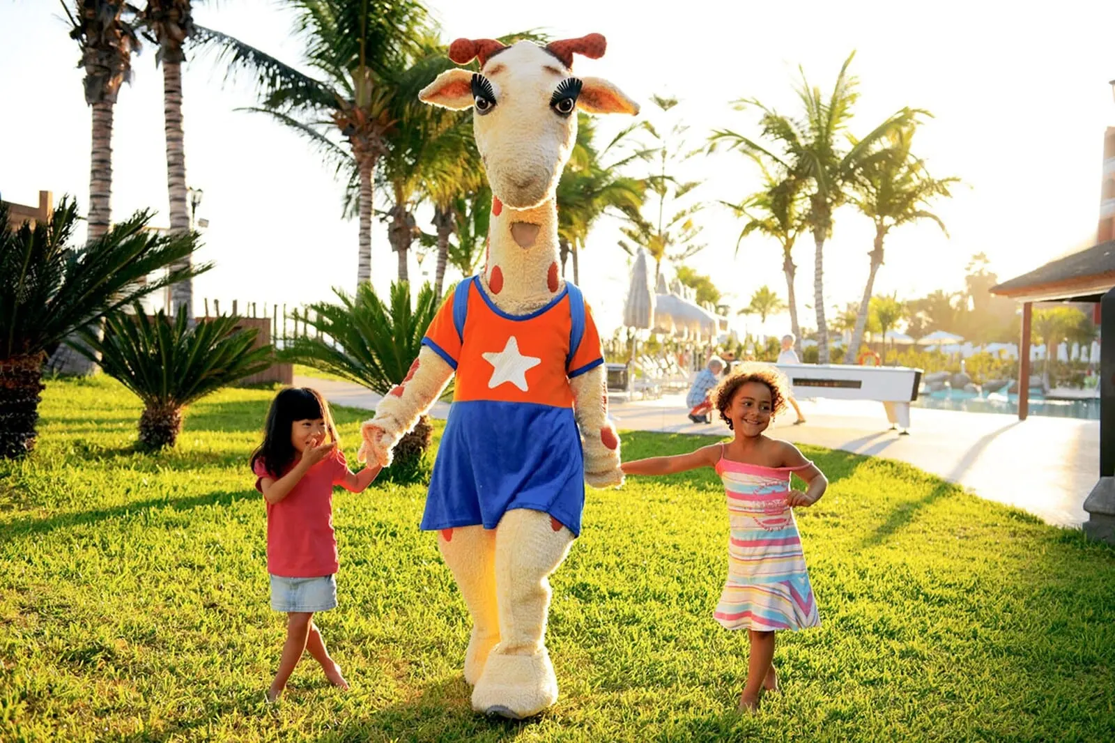 Coral Compostela Beach: A giraffe mascot with a star on its shirt