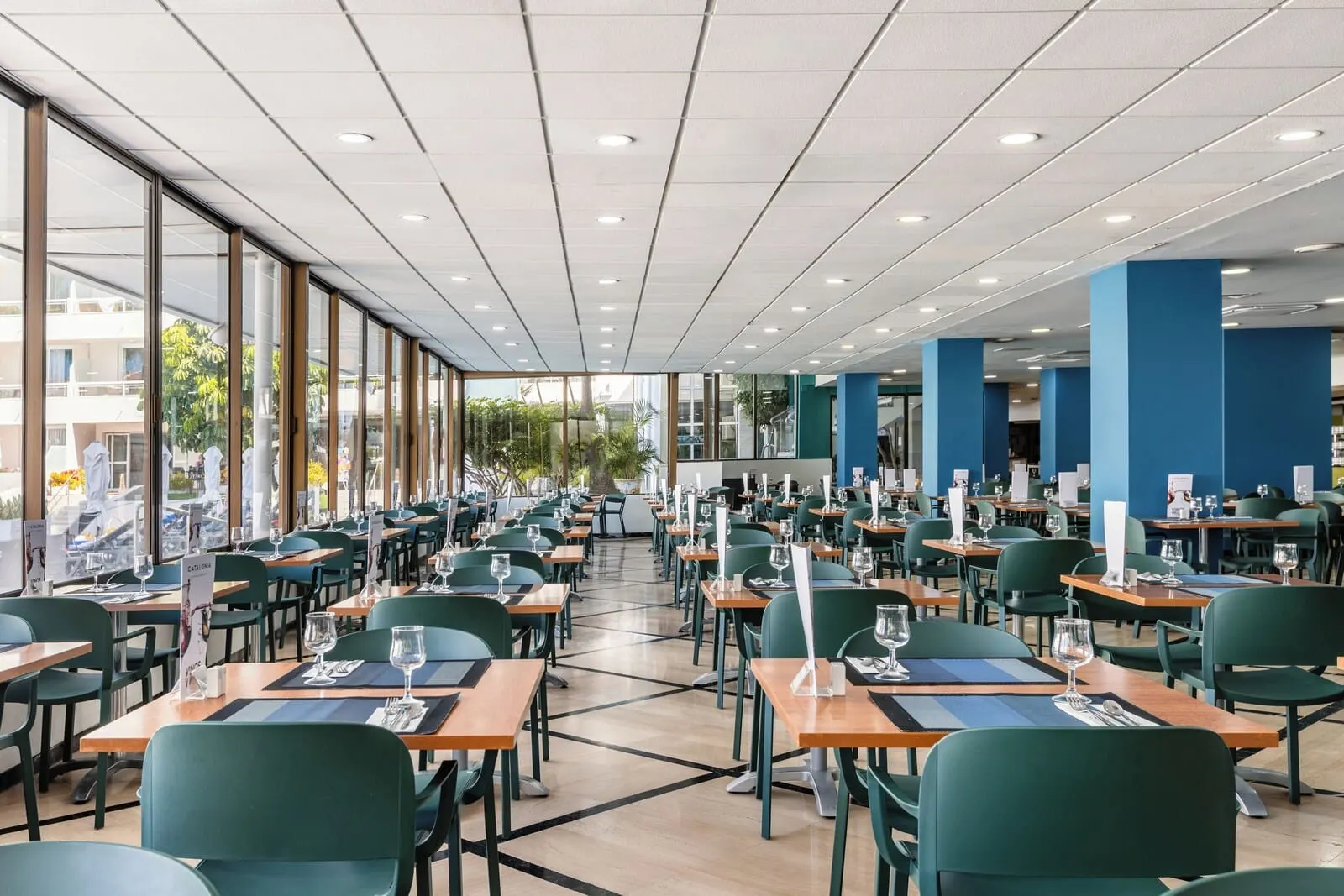 Catalonia Oro Negro: A spacious restaurant with high ceilings, large windows, and a modern interior