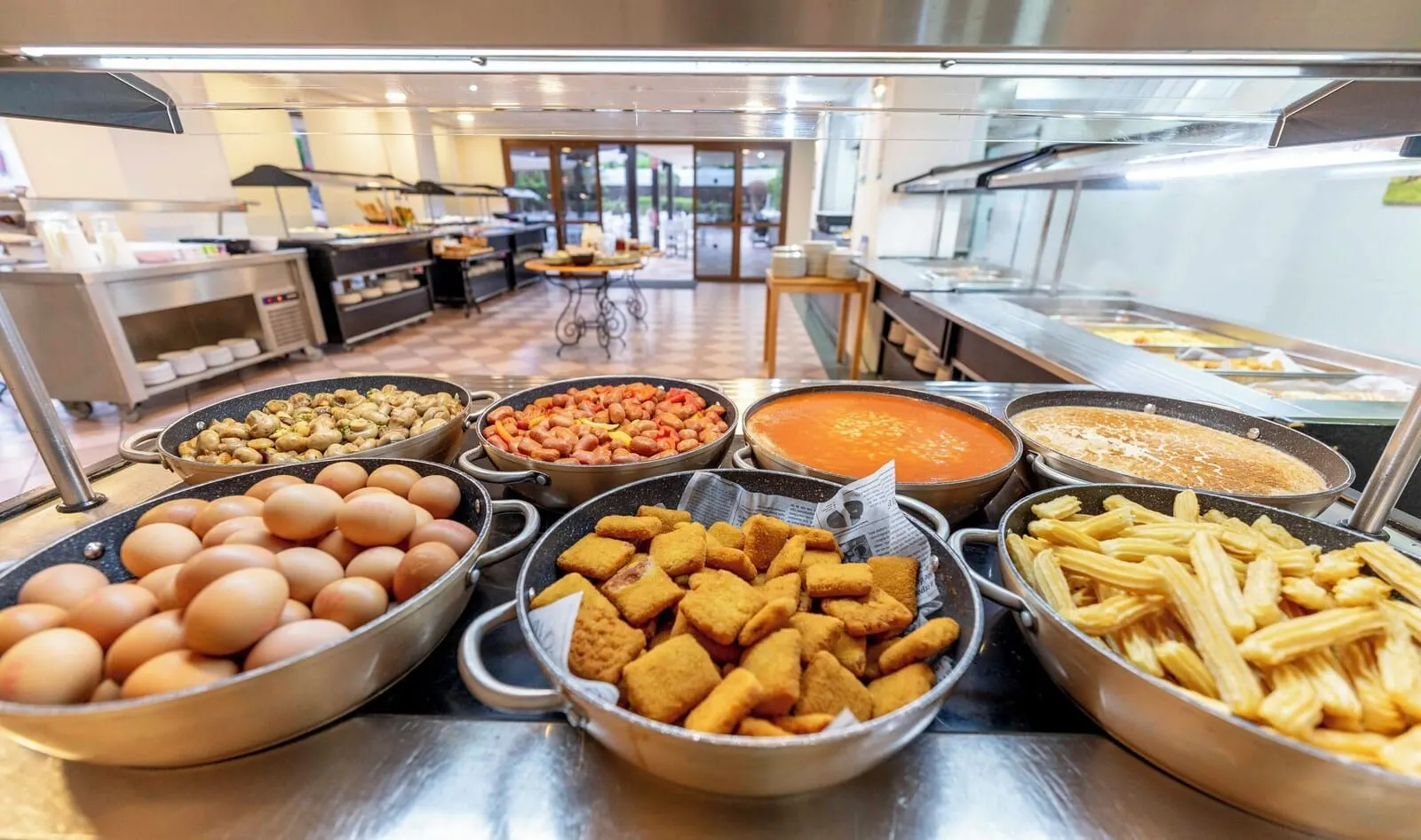 Ona Palm Beach: A buffet with various food items including eggs, mushrooms, beans, soup, and pasta