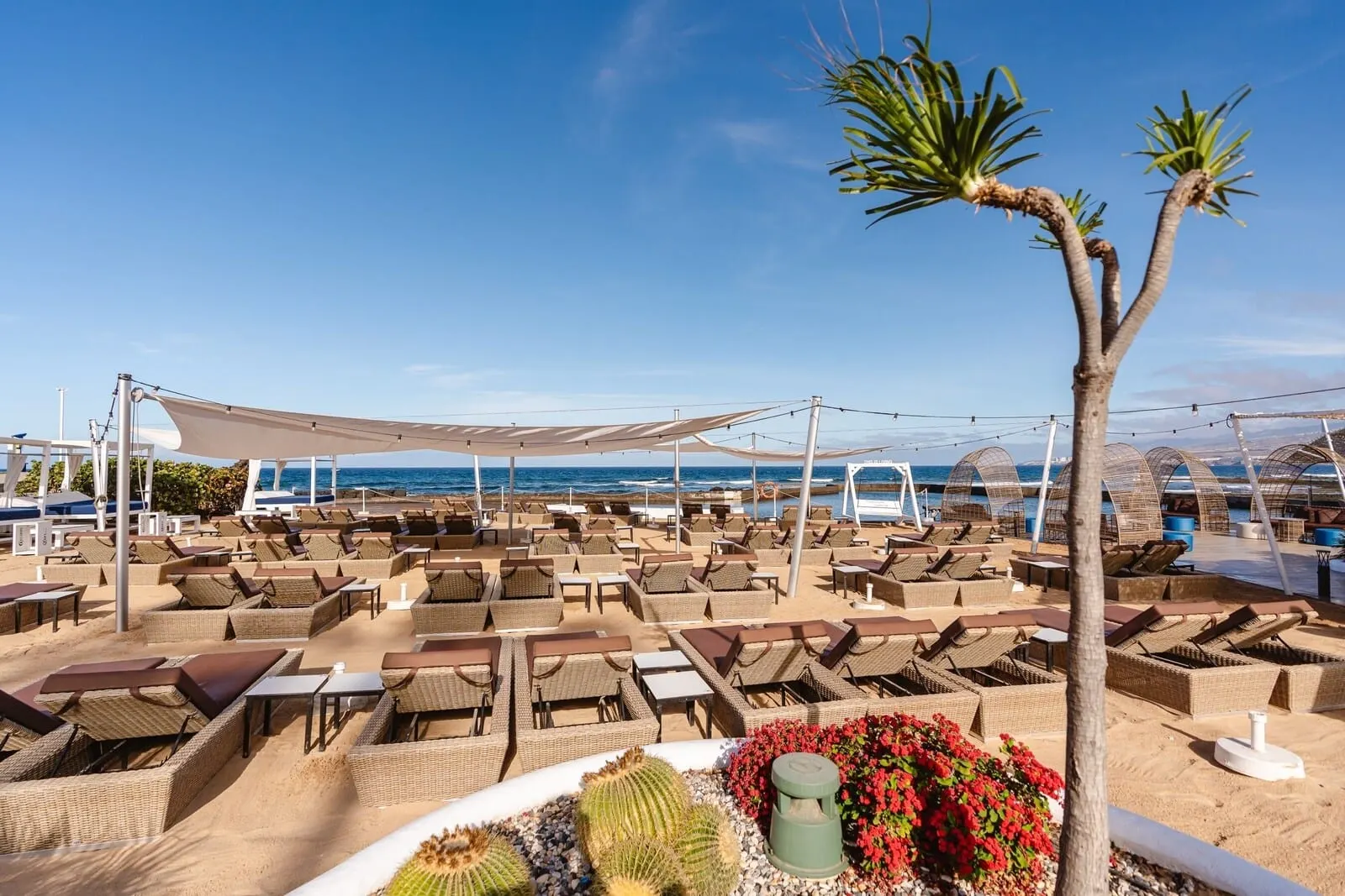 Europe Villa Cortés: A beachside lounge area with wicker furniture and a clear view of the ocean
