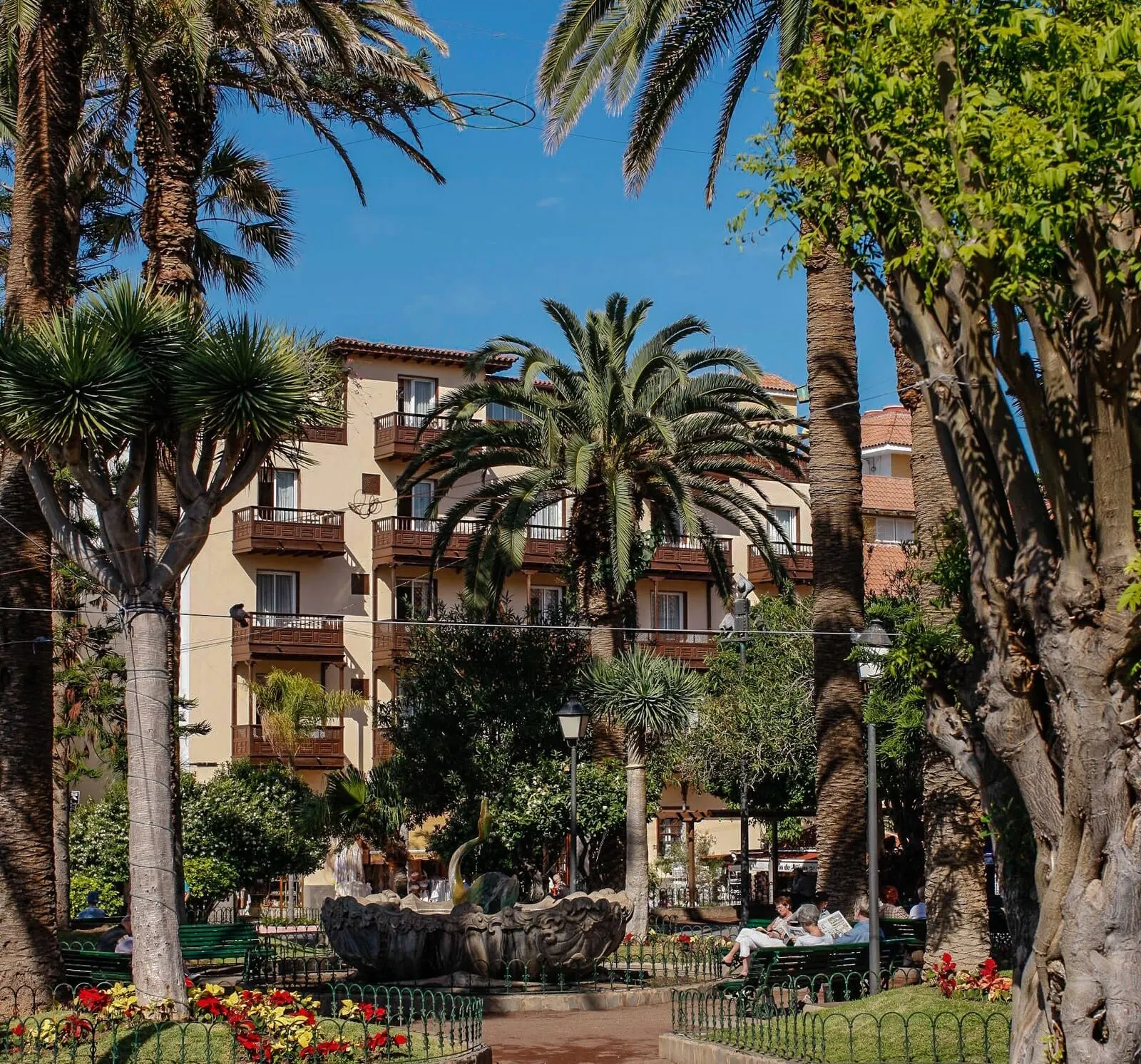 Hotel Monopol: A courtyard with a fountain, palm trees, and a building with balconies