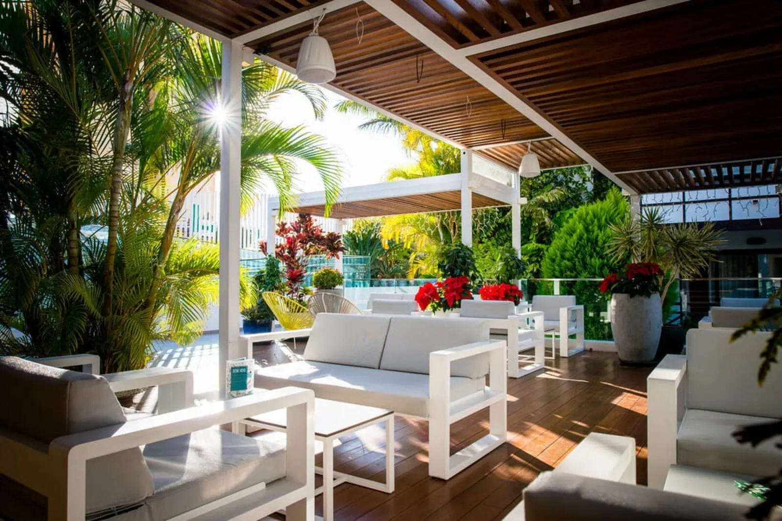 Vanilla Garden Boutique Hotel: An outdoor patio area with white furniture, including sofas and chairs