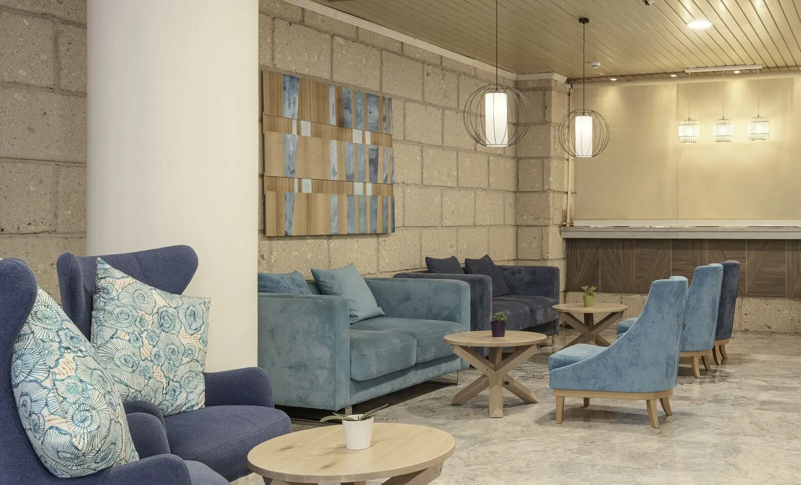 Alua Tenerife: A modern lounge area with sofas, armchairs, and a coffee table