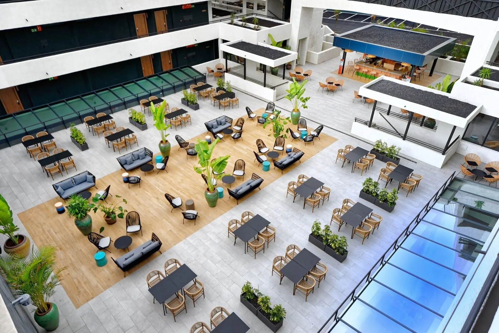 HOVIMA Suites Costa Adeje: A spacious indoor courtyard with multiple seating areas, including sofas, chairs
