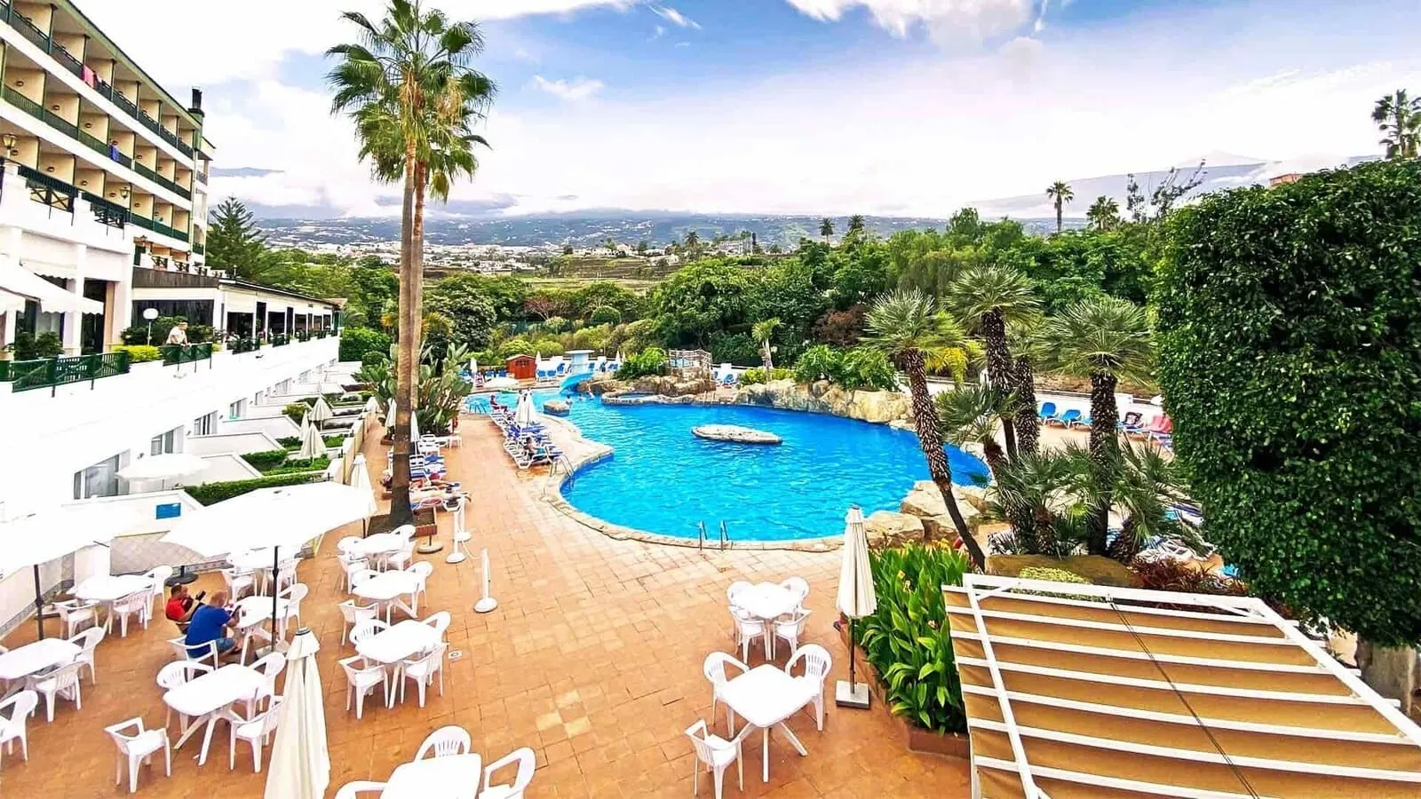 BLUESEA Costa Jardín & Spa: A resort with a swimming pool, outdoor seating, and a view of the landscape