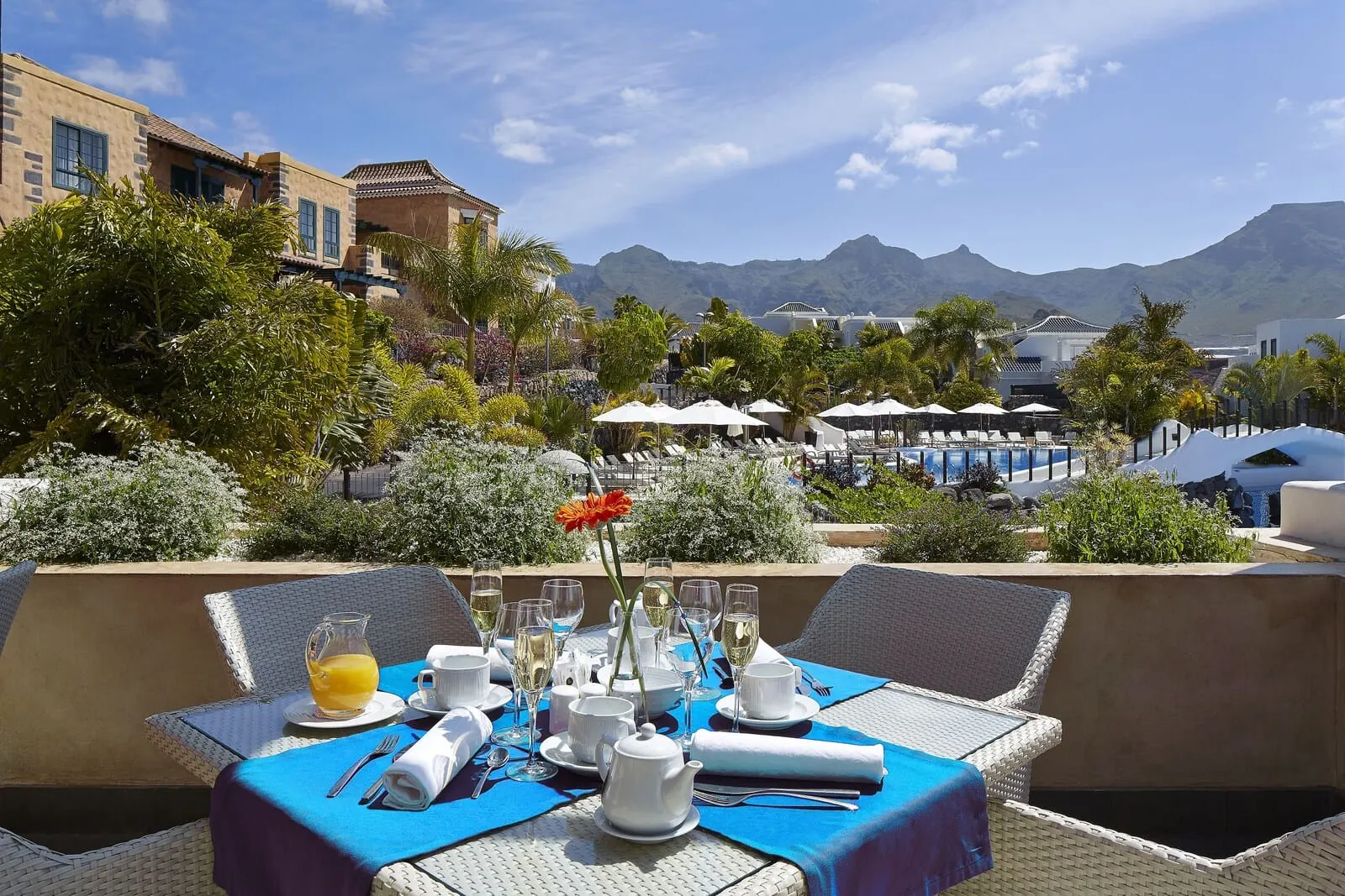 Hotel Suite Villa María: A dining table set with white tableware and a pitcher of orange juice