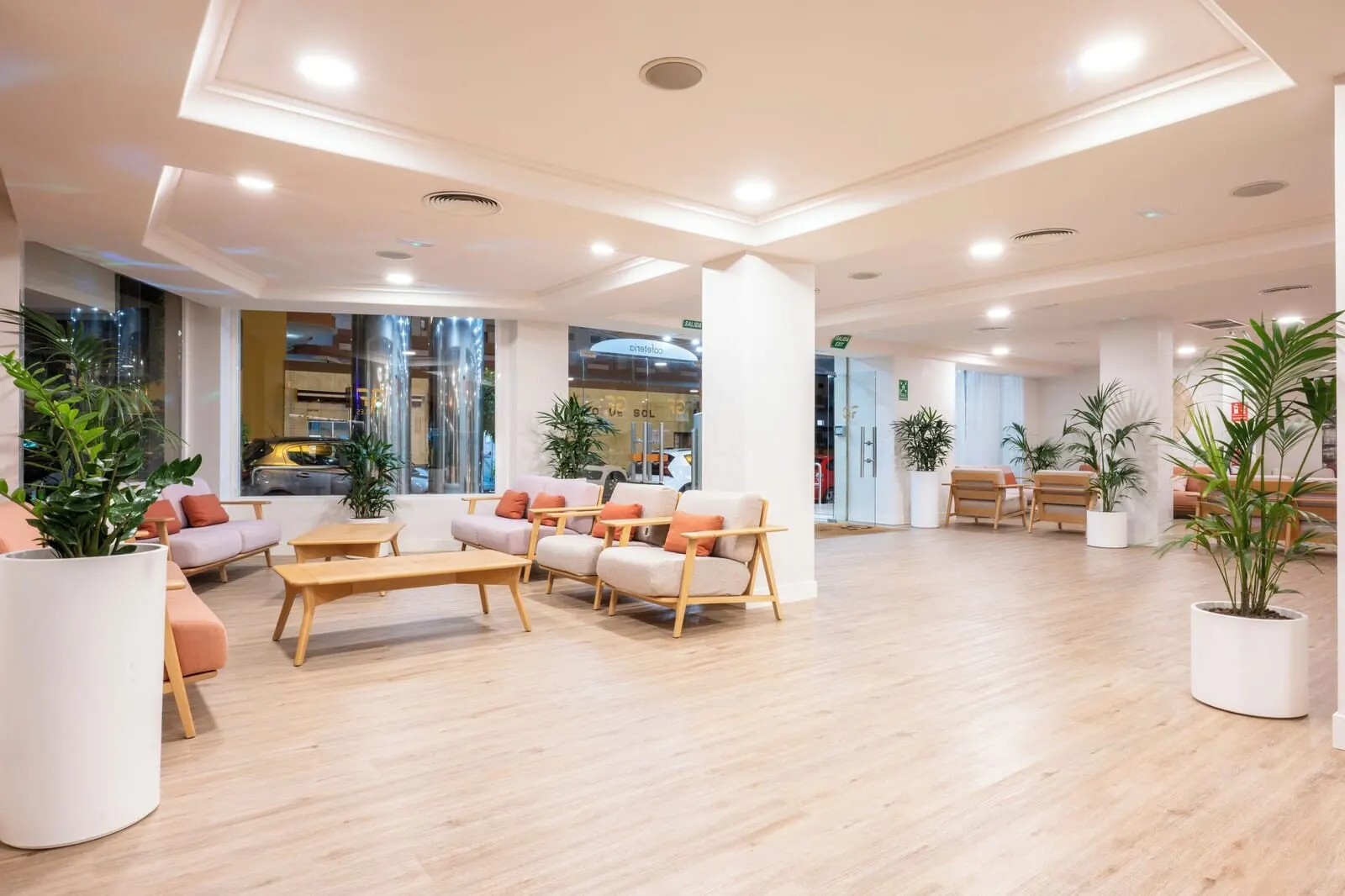 GF Noelia: A spacious lobby with a modern design, featuring a seating area with sofas and chairs