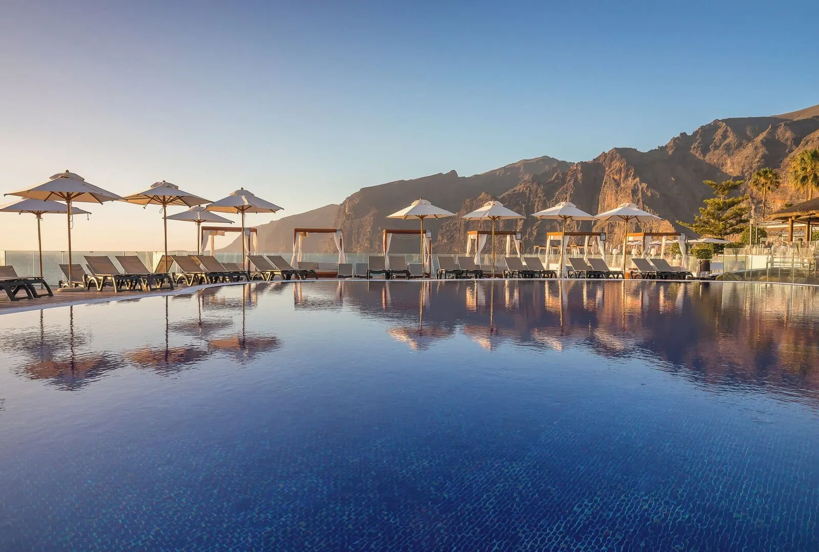 Barceló Santiago: A pool with lounge chairs and umbrellas, surrounded by mountains