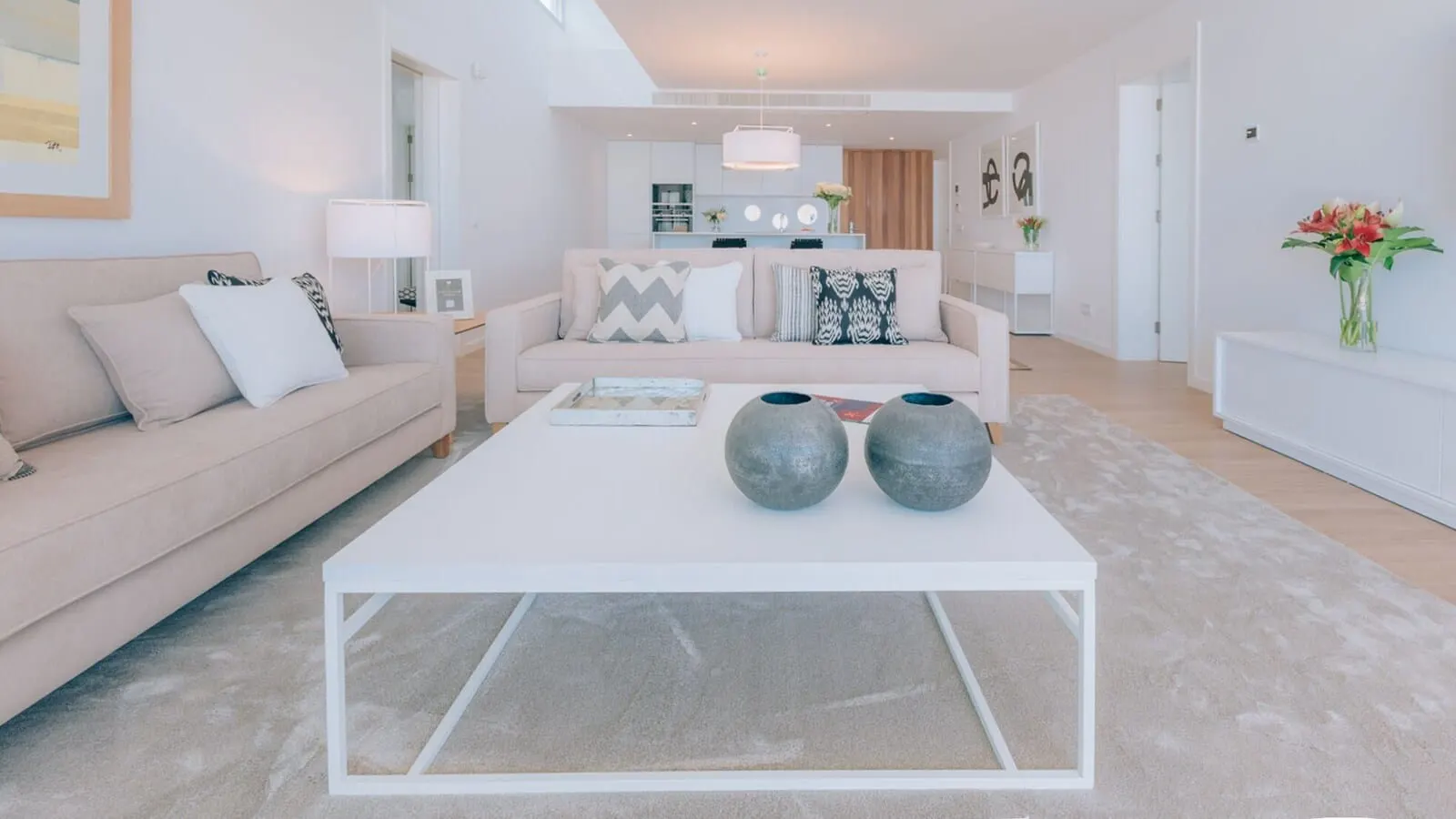 Los Jardines de Abama Suites & Villas: A modern living room with a white sofa, a coffee table with decorative vases